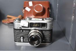 A FED-4 35mm rangefinder cameras, FED 52mm f2.8 lens and brown leather case and strap.