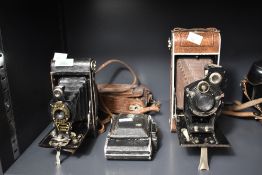 Three folding cameras, a Kodak No.2 Autographic Brownie, a Foth Rollfilm Camera 9.5x11cm, and a