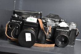 Two Zenit E cameras, one silver and black, the other black, both with Helios 58mm f2 44-2 lenses,