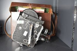 A Paillard Bolex 16mm movie camera, with hand grip, viewfinder, three reels, telephoto lens, zoom