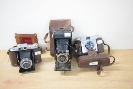Three medium format folding cameras. A Taisei Koki Welmy Six, with a Welmy Terionar 75mm f3.5