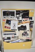 A range of camera booklets and leaflets in a paper folder. Pentax, Olympus, Vivitar, Cokin, Ricoh