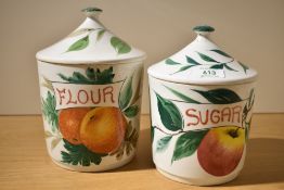 A ceramic sugar jar with cover, hand painted with apple and foliage, h20cm, sold together with a