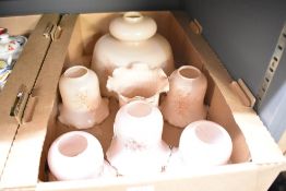 A large pendant light shade in pink milk glass sold with six matching wall light shades.