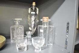 An Art Deco style decanter having cut glass geometric patterns, h22cm, sold together with 1 other
