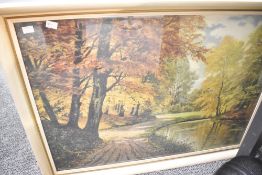A 20th century colour print, autumnal park scene, indistinctly marked lower left, within a moulded