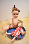 Two Dolls, 1960's Hong Kong Penny Brite Doll wearing red and white dress and a Made in England
