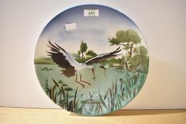 A ceramic plate decorated with stork/heron motif, w30.5cm