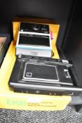 Two Kodak Instant cameras. An EK8 and an EK6