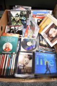A carton of assorted music CDs including the likes of The Verve, Aerosmith, Tom Jones and Simply Red