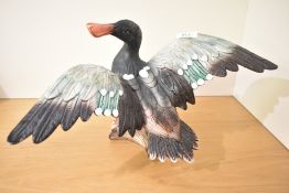 A large ceramic mallard duck study perched on logs, measuring 24cm x 42cm approximately.
