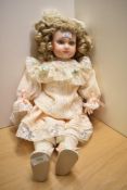 A vintage Franklin Heirloom ceramic headed doll.
