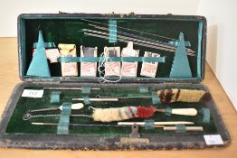 A vintage gun cleaning kit.