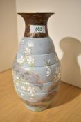 A Doulton & Slaters pottery vase hand painted with floral patterns on a blue ground, h25cm
