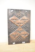 A 20th-century African-style decorative copper wall art panel, featuring a relief design of repeated