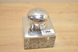 A George V silver mounted cut glass inkwell, of square form having a circular cap engraved 'B.P.',