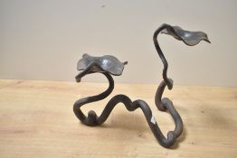 A 20th-century hand-wrought iron serpentine Art Nouveau-style candle holder, featuring a flowing,