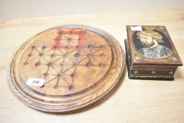 A 20th-century wooden Solitaire board with glass marbles, game pieces are kept in a painted wooden