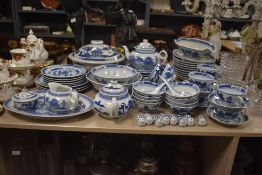 A 20th-century Chinese Blue Willow-style dinner set, featuring blue landscapes of pagodas,