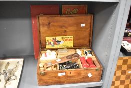 A 19th to early 20th-century wooden hinged-lid box, featuring an array of games and game board