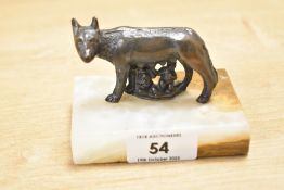 A small contemporary patinated metal model of the Capitoline Wolf, set upon a marble base, measuring