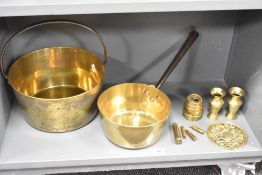 A selection of 20th-century brassware, to include a pan, bucket, four bullet cases, a pair of
