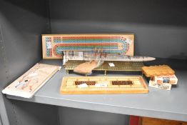 A collection of late 20th-century to modern cribbage boards, which are used to keep score in the