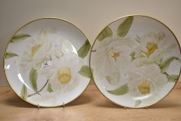 A pair of large decorative plates having hand painted design and gilt decoration to rim, with script