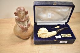 Two 20th-century hand-crafted pipes, to include an SMS Turkish block meerschaum pipe carved with a