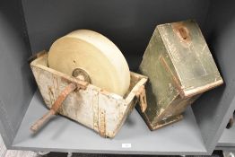 A Victorian sand stone grinding/sharpening wheel, featuring a large, circular stone wheel and a hand