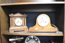A late 19th or early 20th Century mahogany cased mantel clock of architectural form having enamelled