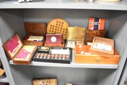 A large collection of 20th-century game sets in a variety of wooden and metal boxes, including The
