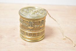 An Edwardian brass decorated desk top string holder, featuring a repeating swag and pendant