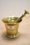A 20th-century brass pestle and mortar, (2).