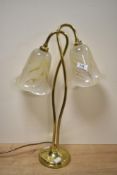 A late 20th-century twin brass swan-neck table lamp, featuring tulip-shaped glass shades, 53cm.