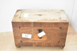 A 19th-century figured mahogany and rose wood tea caddy, featuring a hinged lid with an angular