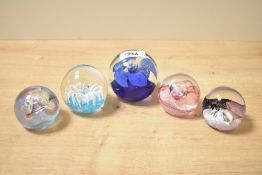 A Caithness 'Mooncrystal' pattern glass paperweight, h5cm, sold together with four similar