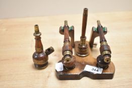 A 20th-century Arabic-style wooden tobacco pipe rack, to include two wooden tobacco pipes adorned