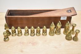 A selection of 20th-century Tigani Gothic-style brass chess pieces, with wooden storage box, (14).