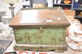 A 20th-century wooden storage trunk, with a hinged lid and an exterior painted in a faded green hue,