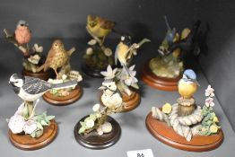 A collection of late 20th-century Country Artists hand-painted and hand-crafted bird figurines,