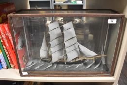 A 20th-century sailing ship diorama in a glass-fronted case, featuring a modelled sea base, 48cm,