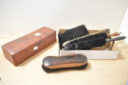 A group of cleaning brushes and an Oriental laquered box