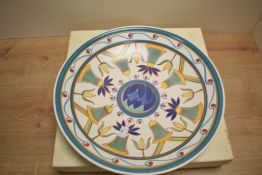 A large decorative Poole Pottery charger, of dished circular form decorated with repeating