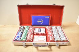 A late 20th-century 300-piece poker set in a metal carry case, including chips, dice, playing cards,