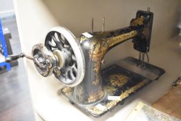 An early 20th-century Singer 103 sewing machine, featuring the iconic gold Sphinx decals,