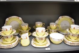 A 20th-century English Heathcote Best Bone China tea set, in soft yellow, featuring a decorative