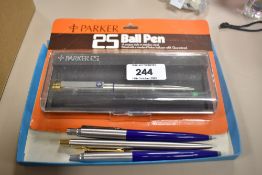 Four Parker Ballpoint pens. An unopened boxed Parker 25, a brushed steel with gold trim Parker