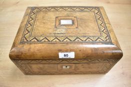 An early 20th-century marquetry inlaid jewellery box, featuring detailed geometric patterns to the