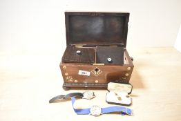 A 19th century rosewood tea caddy of sarcophagus form, supported on bun feet, decorated with pearl